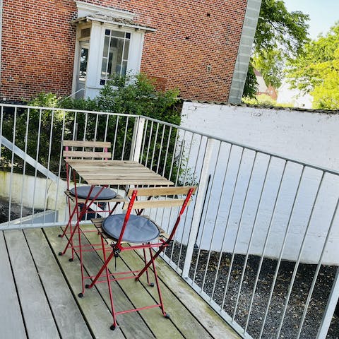 Enjoy your morning coffee on the balcony overlooking the shared garden below