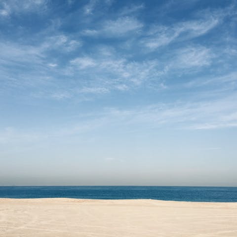 Sink your feet into the white sands, you have direct beach access from your apartment building