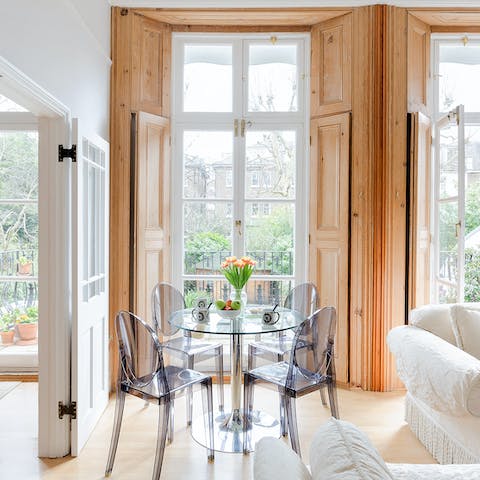 Sit down to a meal framed by floor-to-ceiling windows giving way to garden views