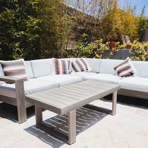 Relax on the huge outdoor sofa and catch some rays