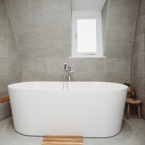Savour a luxurious soak in the freestanding bathtub
