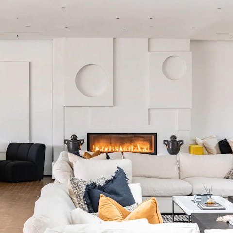 Get cosy in front of the fireplace in the stylish living area