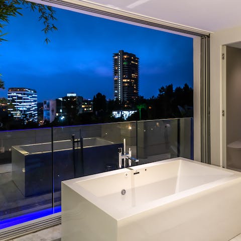 Pamper yourself in the luxurious jet tub overlooking the LA skyline