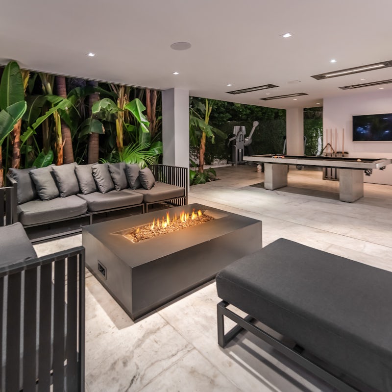 Kick back in the covered lounge by the fire pit, play pool, or workout in the outdoor gym