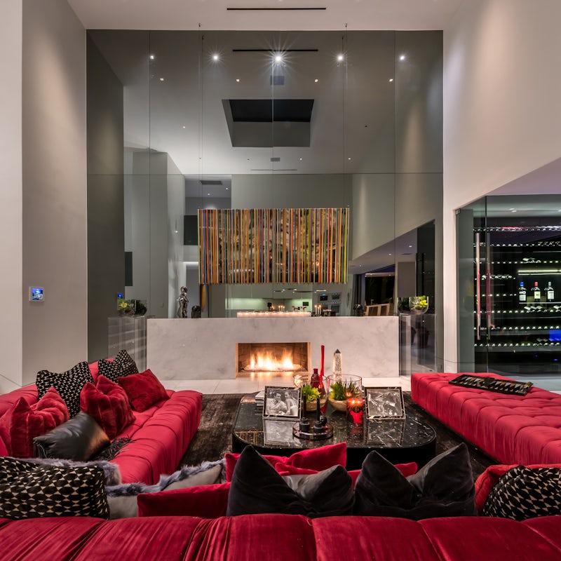 Recline on the huge U-shaped sofa in front of the fire, a glass of red plucked from the wine cellar in your hand