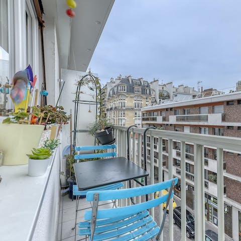 Sip red wine on the petite balcony and watch the busy streets below