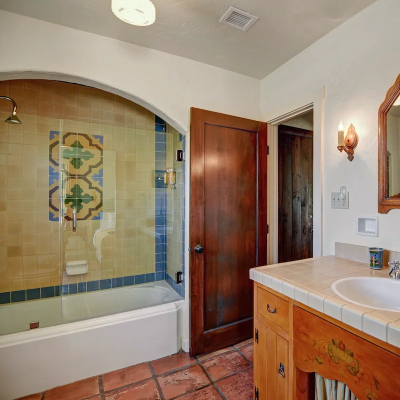 Sink back into bubbly water in the pretty tiled bathtub