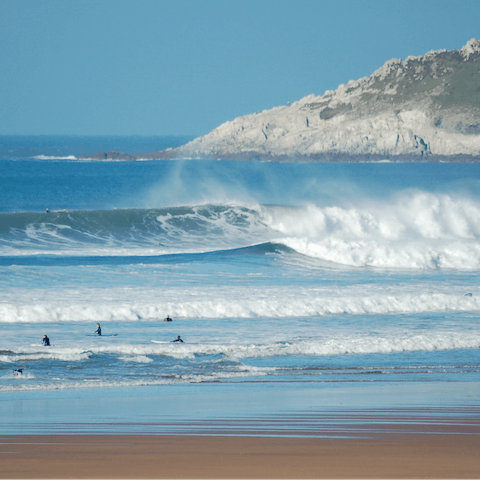 Attempt standing up on a wave on Woolacombe Beach, a short drive away