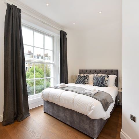 Wake up to floor-to-ceiling views of leafy Markham Square in the second bedroom