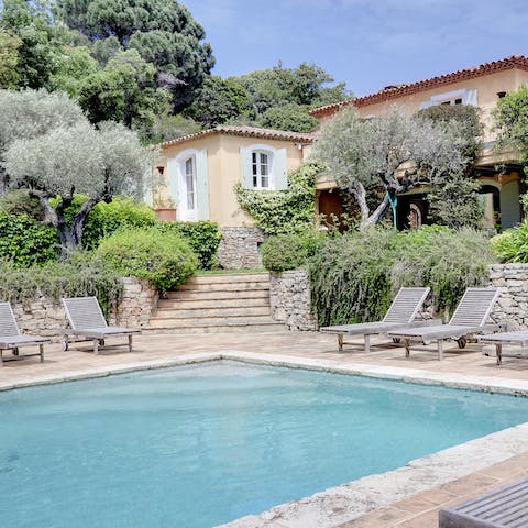 Jump into the home's swimming pool surrounded by peaceful nature