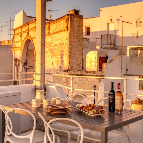 Dine on your private roof terrace, overlooking the whitewashed townscape