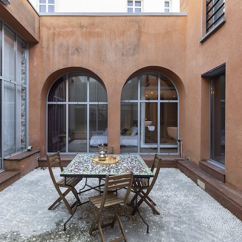 Sip wine in the patio, which the ground floor is arranged around