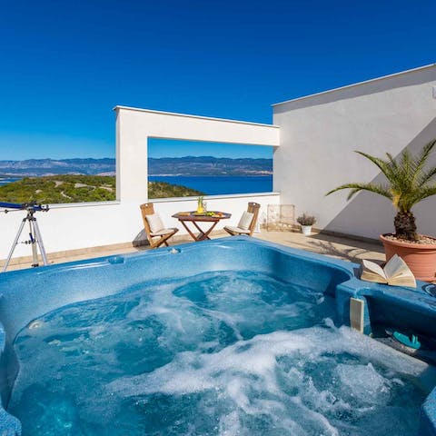 Relax in the warmth of the jacuzzi, overlooking the Aegean Sea