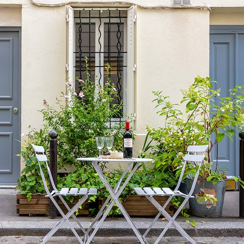 Share a romantic evening at the table outside your apartment 