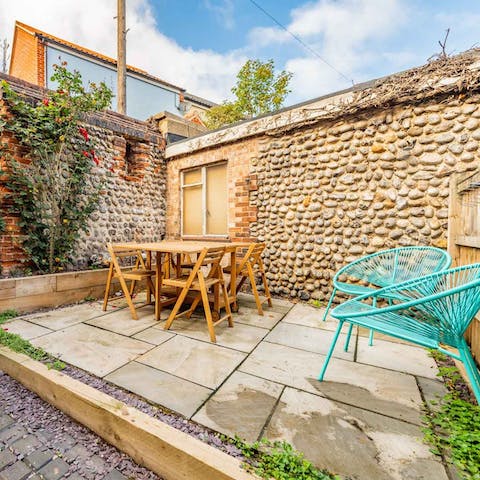 Relax in the courtyard garden with its high brick and flint walls