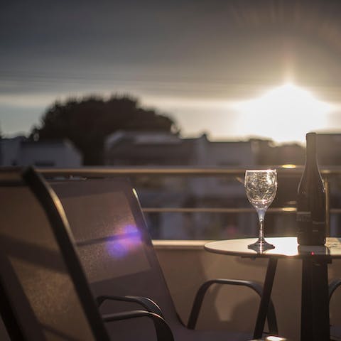 Sip a glass of wine on the balcony as the sun goes down