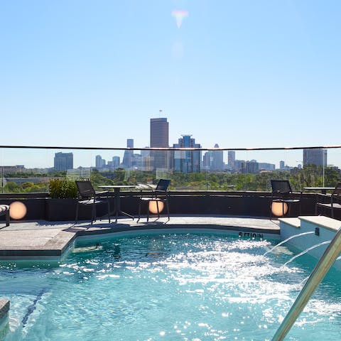 Head up to the building's rooftop terrace for a dip in the pool with a stunning cityscape view