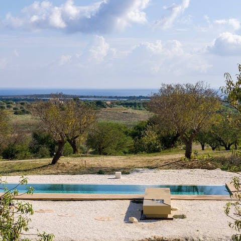 Float in the pool and admire the landscaped garden and sea views