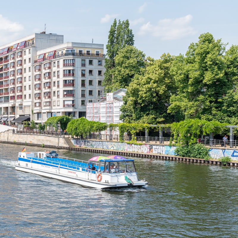 Walk for a minute across the train tracks to picnic by the calming river Spree