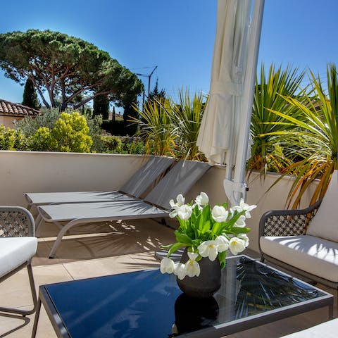 Soak up the sunshine on one of the loungers on the upper-floor terrace