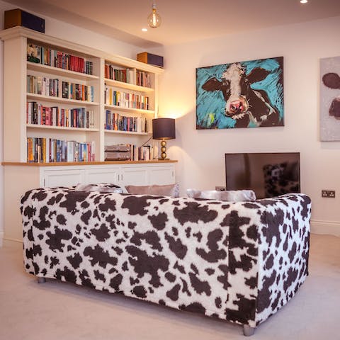 Sprawl out on the funky cow-patterned sofa and rest weary feet after a seaside stroll
