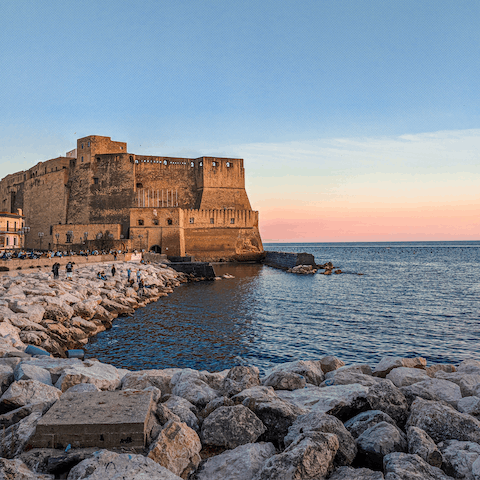 Watch the sunset from Naples' rocky shores, less than a ten-minute walk away