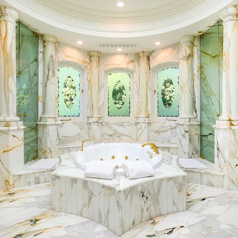 Freshen up before dinner in the master suite's stunning marble bathroom