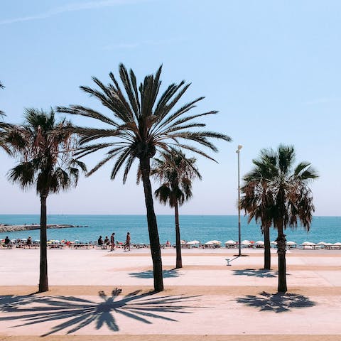 Stretch out on the sand of Barcelona's bustling urban beach – Playa Barceloneta is 2.5km from your front door