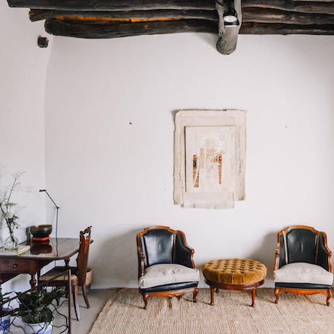 Catch up on a couple of emails at the antique desk in the light-filled living room