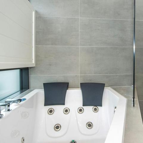 Unwind and ease and aches and pains on the Jacuzzi tub