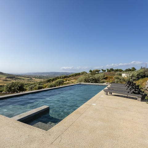 Admire the countryside views as you relax by the pool