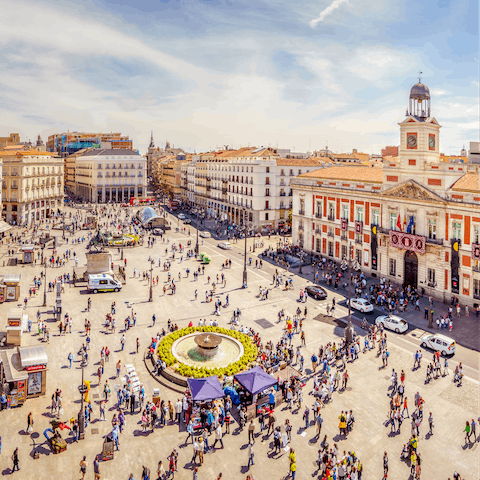 Visit bustling Puerta del Sol, a ten-minute stroll from your door