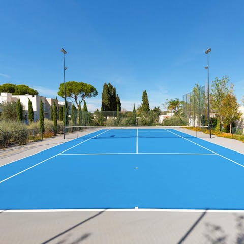 Get your morning sets in on the private tennis court