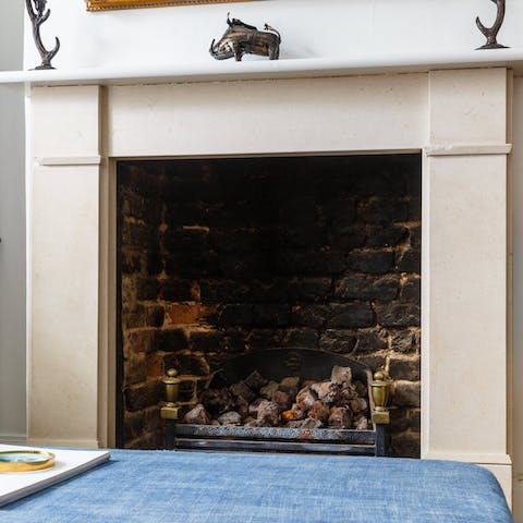 Cosy up around the intricate fireplace