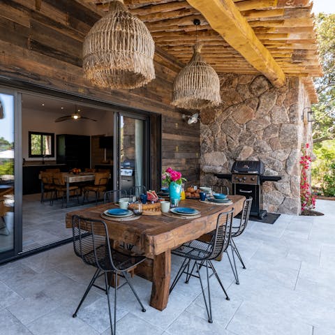 Gather around the outdoor dining table for barbecue feasts and drinks before catching sunset by the pool
