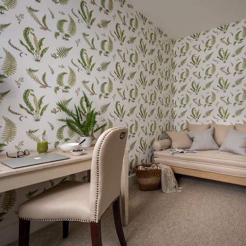 Catch up on work or relax on the sofa in the botanical papered snug
