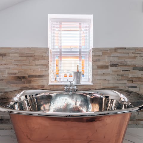 Run yourself a hot bubble bath and soak your cares away in the copper tub