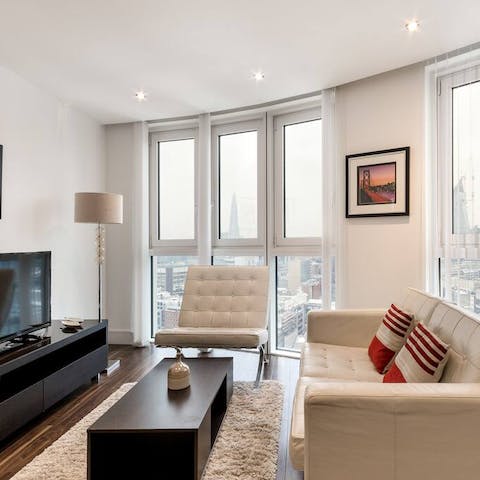 Relax in your light-filled apartment, high above the hustle and bustle of the city streets below