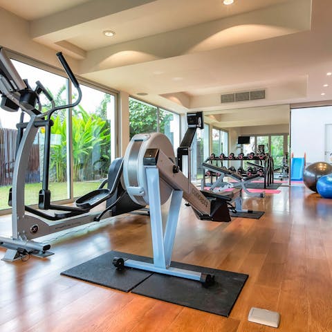 Start your days with an invigorating workout in your private gym with views of the tropical garden