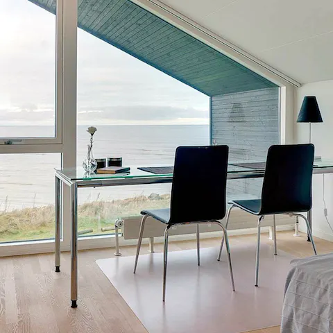 Send a few work emails from the desk in the bedroom – complete with a sea view