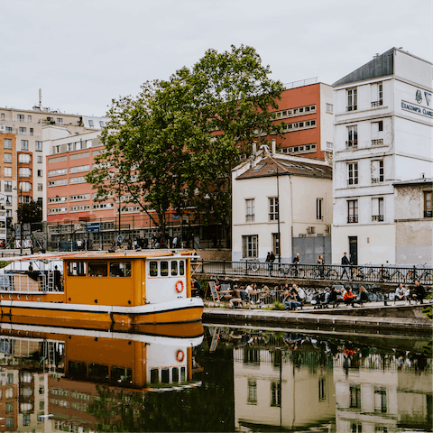 Enjoy an afternoon stroll along the Canal Saint-Martin, a nine-minute walk away