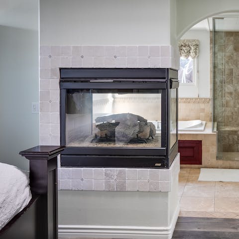 Create an ambiance with the master bedroom's feature fireplace