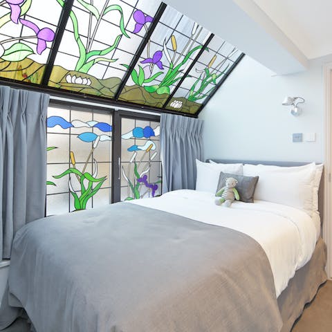Get some rest in the bedroom with the pretty stained-glass windows