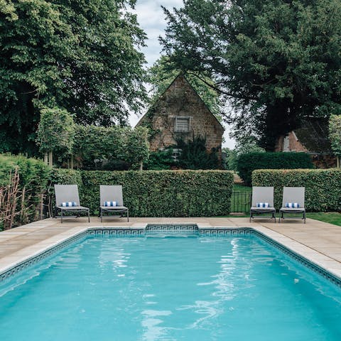 Take a dip in the heated pool hidden away by manicured hedgerows