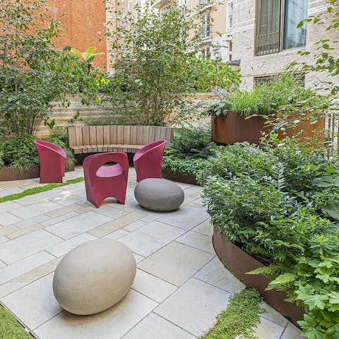 Breathe in the fresh air in the communal courtyard with a drink