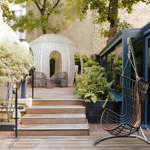 Soak up some rays over your holiday read in the leafy communal courtyard