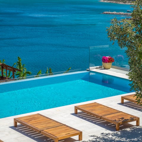 Lay out poolside under the Cretan sun or take a swim in the infinity pool, where land meets sea 