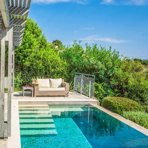 Grab a magazine and relax by the private pool for a while