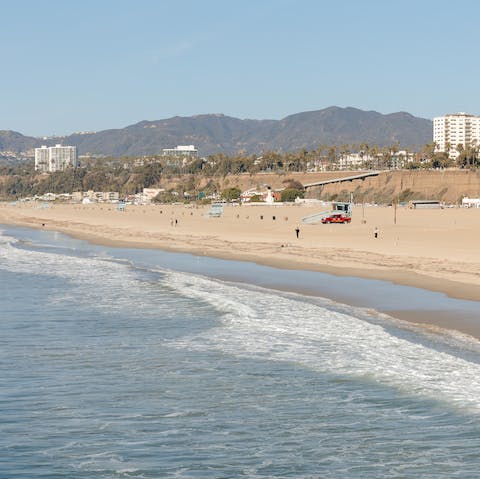 Stroll along the golden sand of Santa Monica Beach, just footsteps away