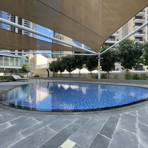 Laze on loungers in the shade before luxuriating in the outdoor, communal pool